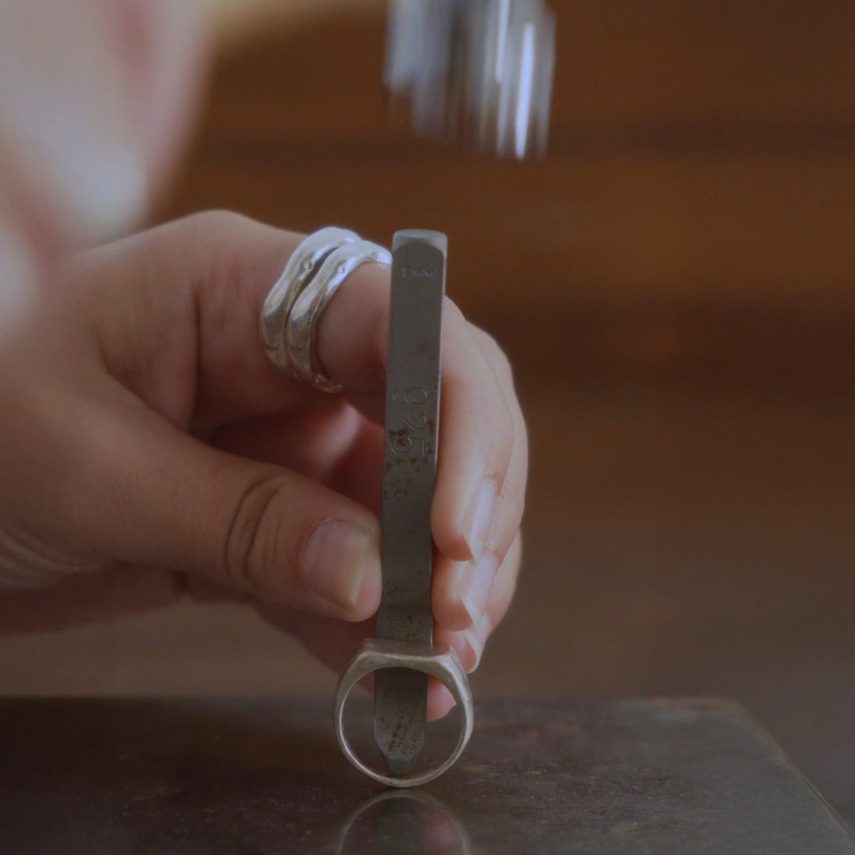 Hand filing a jewelry piece in the BARSHA studio