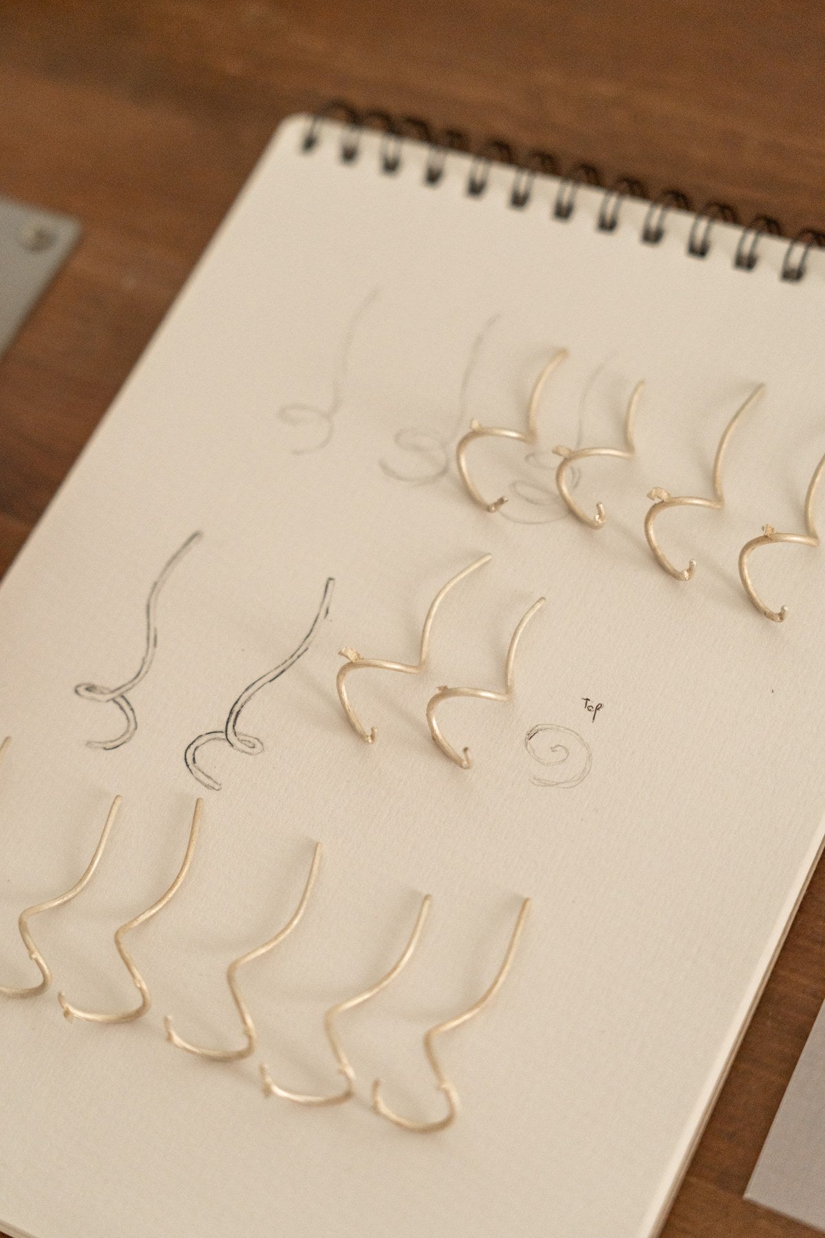 Jewelry models arranged on a sketchbook