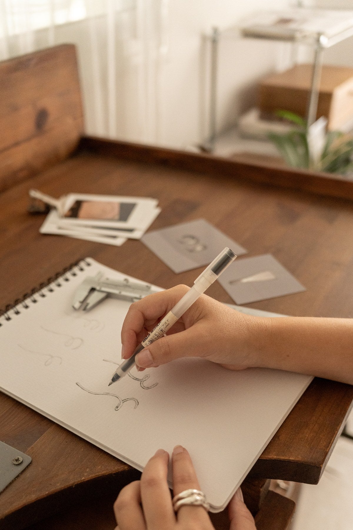 Sketching jewelry designs at the studio desk